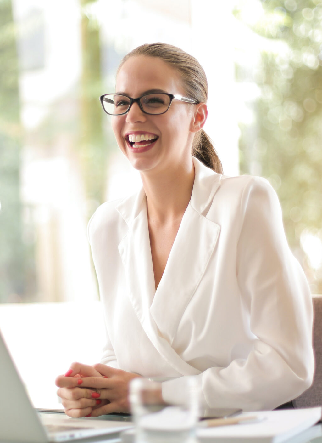 Female doctor laughing at desk